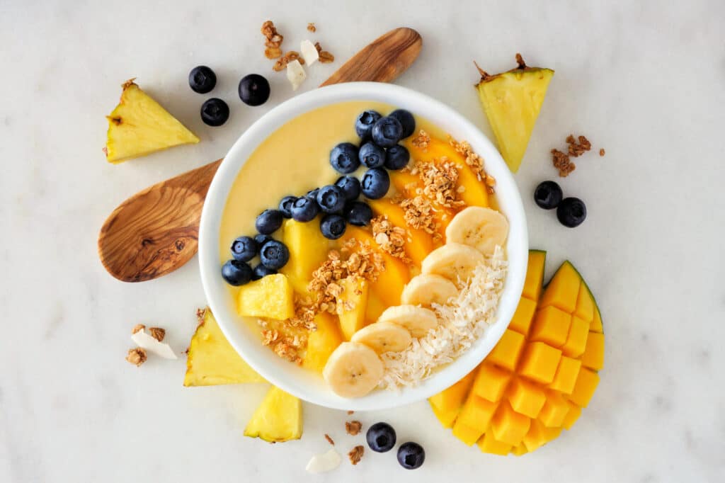 Healthy,Pineapple,,Mango,Smoothie,Bowl,With,Coconut,,Bananas,,Blueberries,And